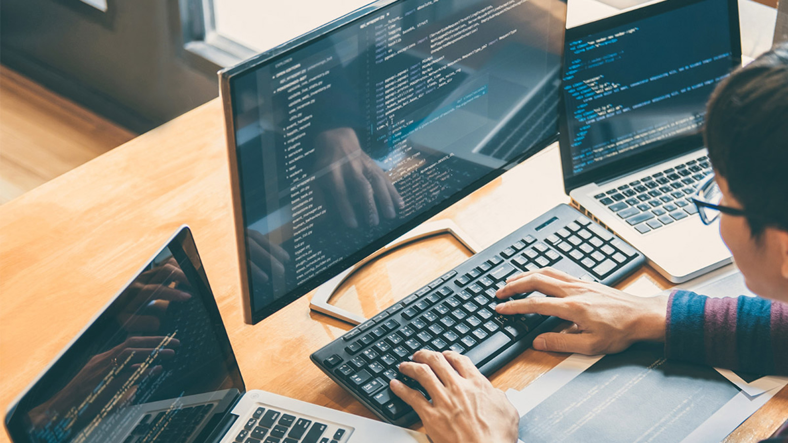 Person coding on a computer