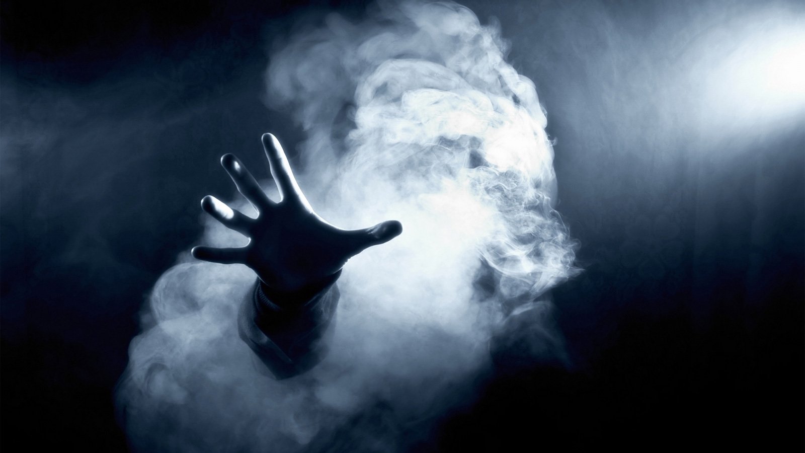 Hand reaching out from smoke