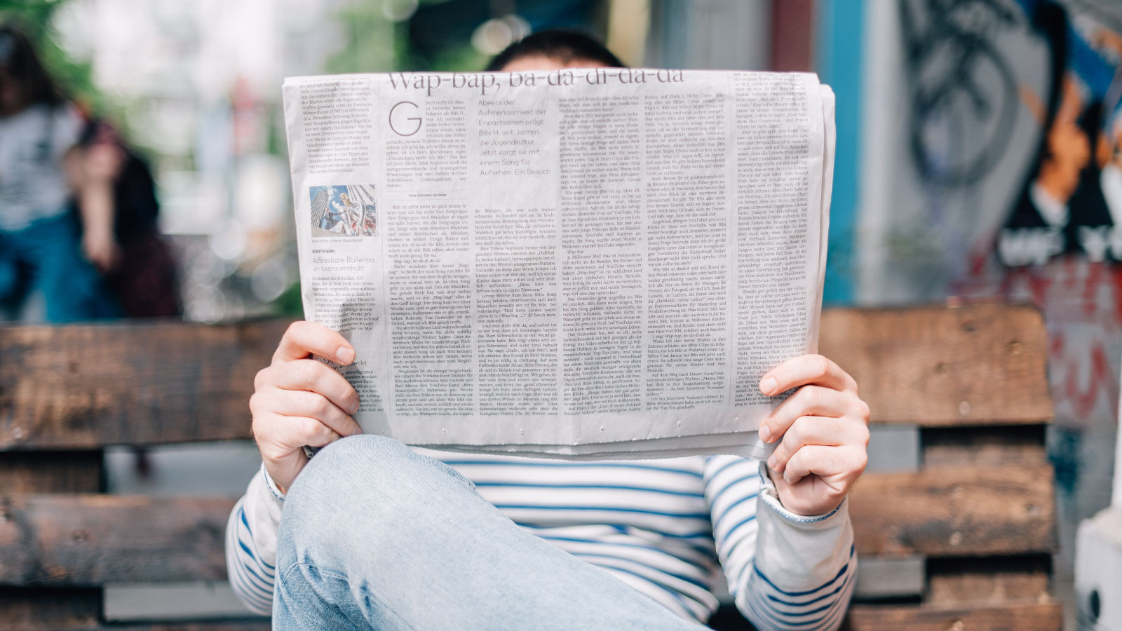 A person reading a newspaper