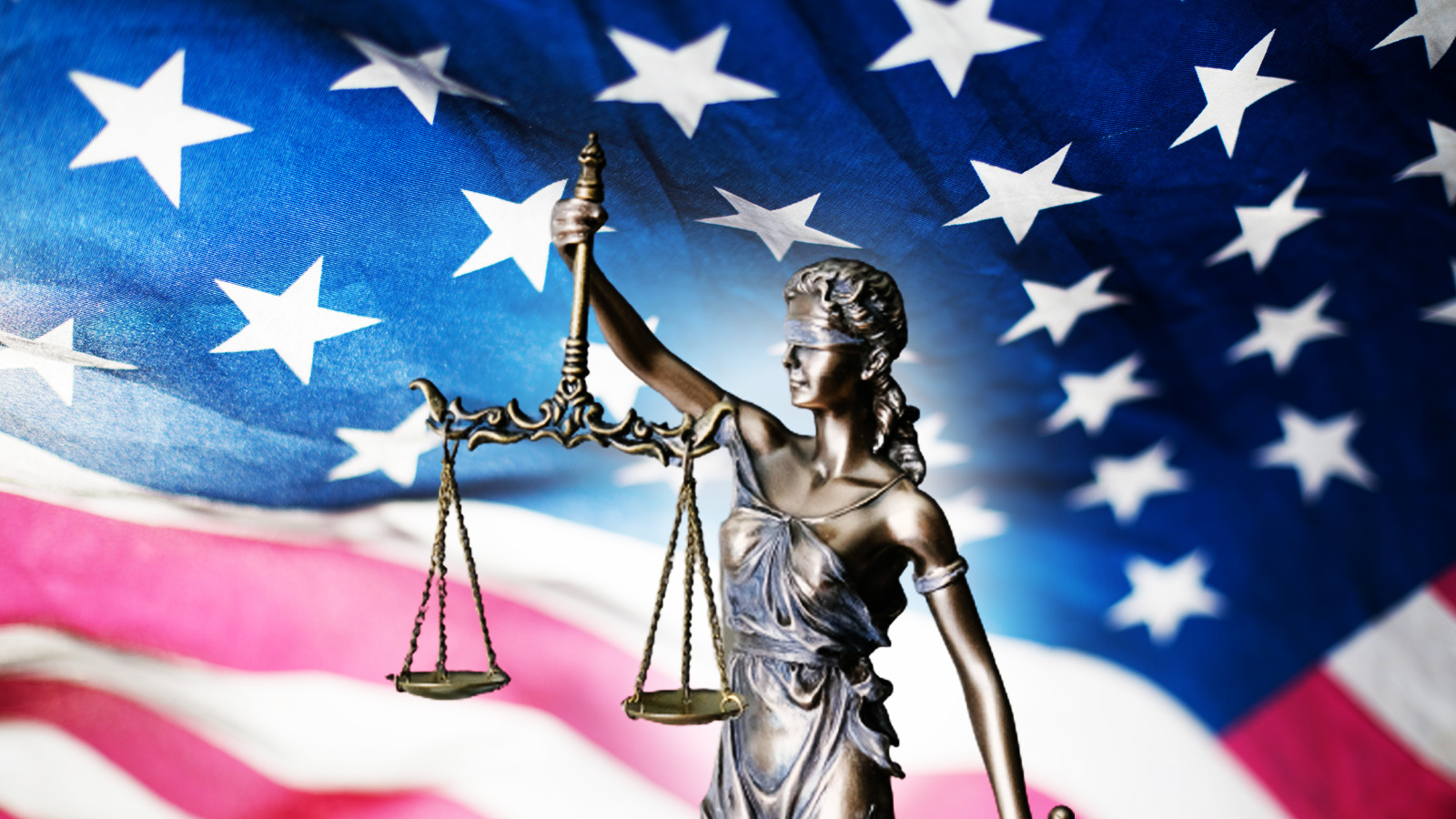 Lady Justice over a USA flag