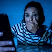 Woman shocked looking at phone