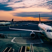 airplane parked by aerobridge 1600x900