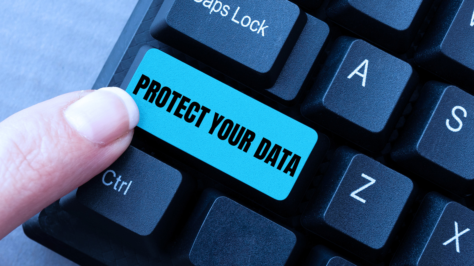 Person pressing a Protect You Data button on a keyboard