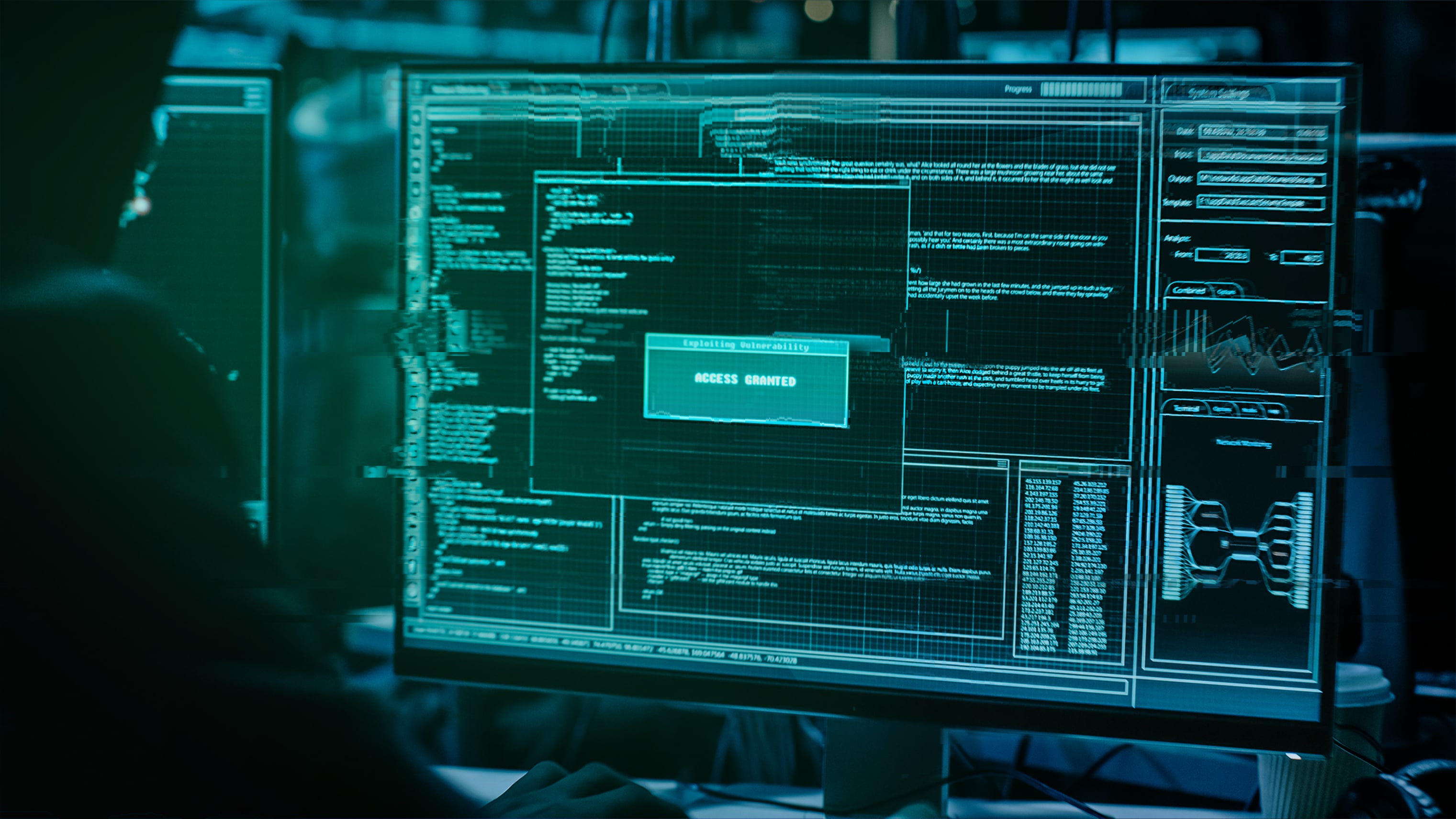 Hacker looking at a computer screen