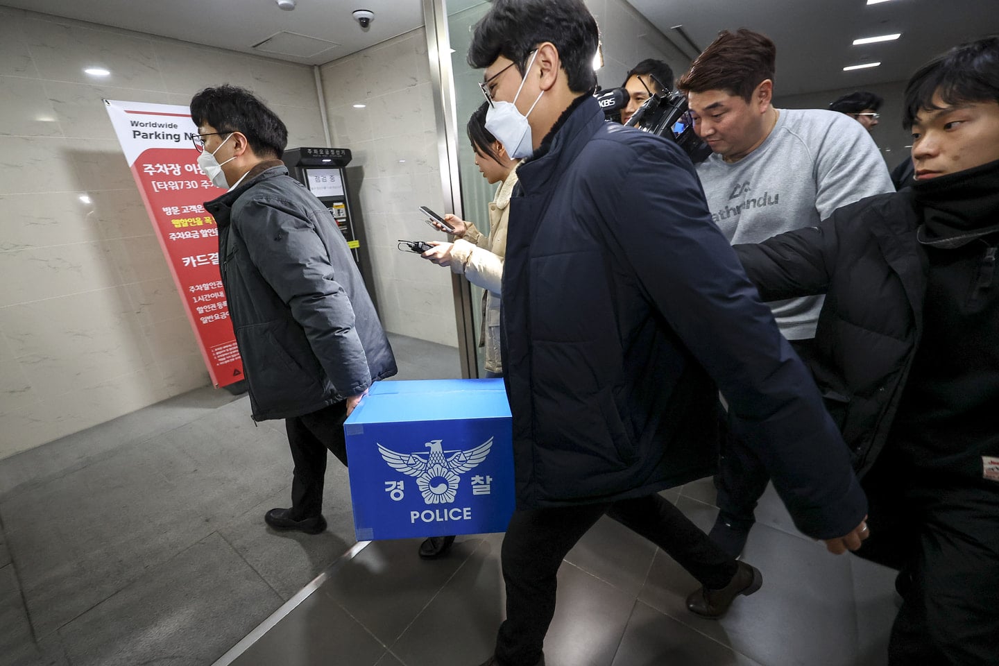 Police transporting seized documents out of Coupang's office